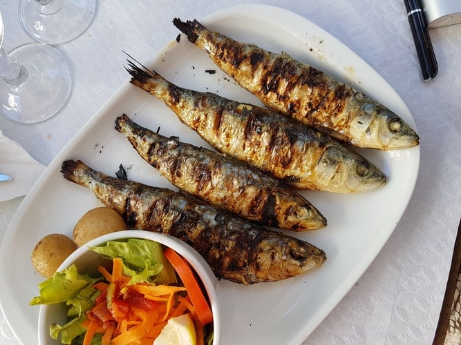 Sardinhas asadas, Portuguese Food, Portuguese cuisine, traditional Portuguese food, food in Portugal, Portuguese dishes